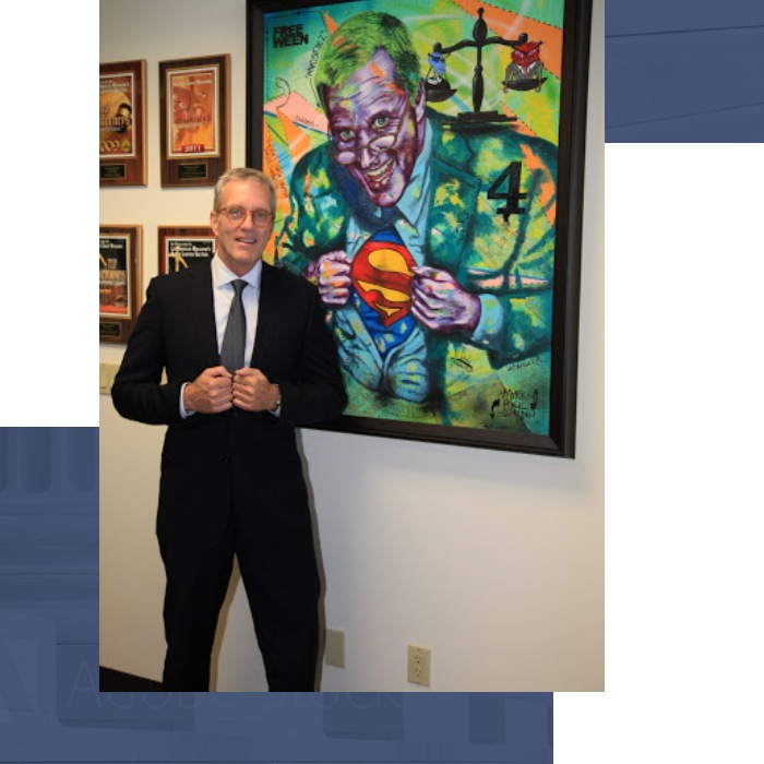 Photo of Attorney David Swanson standing next to a superman painting that looks like him
